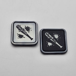 May include: Two black and white iron-on patches with a barbed wire baseball bat and blood splatter design. The patches are square and have a white border.