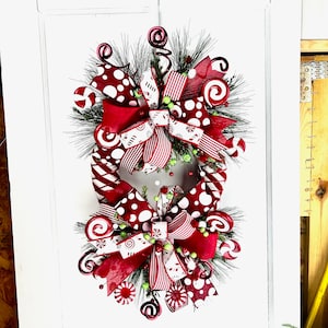 Whimsical Christmas Holiday red and white candy wreath for front door. Christmas door decor, Entry way decoration for your home.