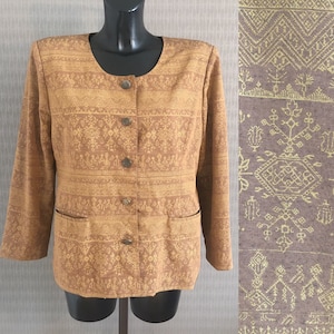 May include: A brown blazer with a gold geometric pattern. The blazer has a round neckline, four buttons down the front, and two pockets.