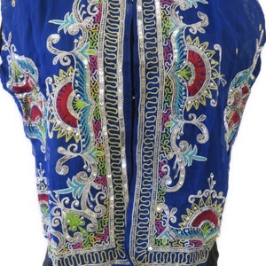 May include: A blue sleeveless vest with colorful embroidery and sequins. The embroidery features floral and geometric patterns.