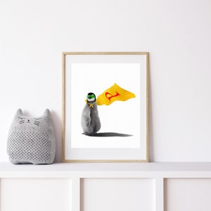 May include: A framed illustration of a penguin wearing a yellow cape with a red letter 'P' on it. The penguin is wearing a green mask and has a yellow band around its neck. The background is white.