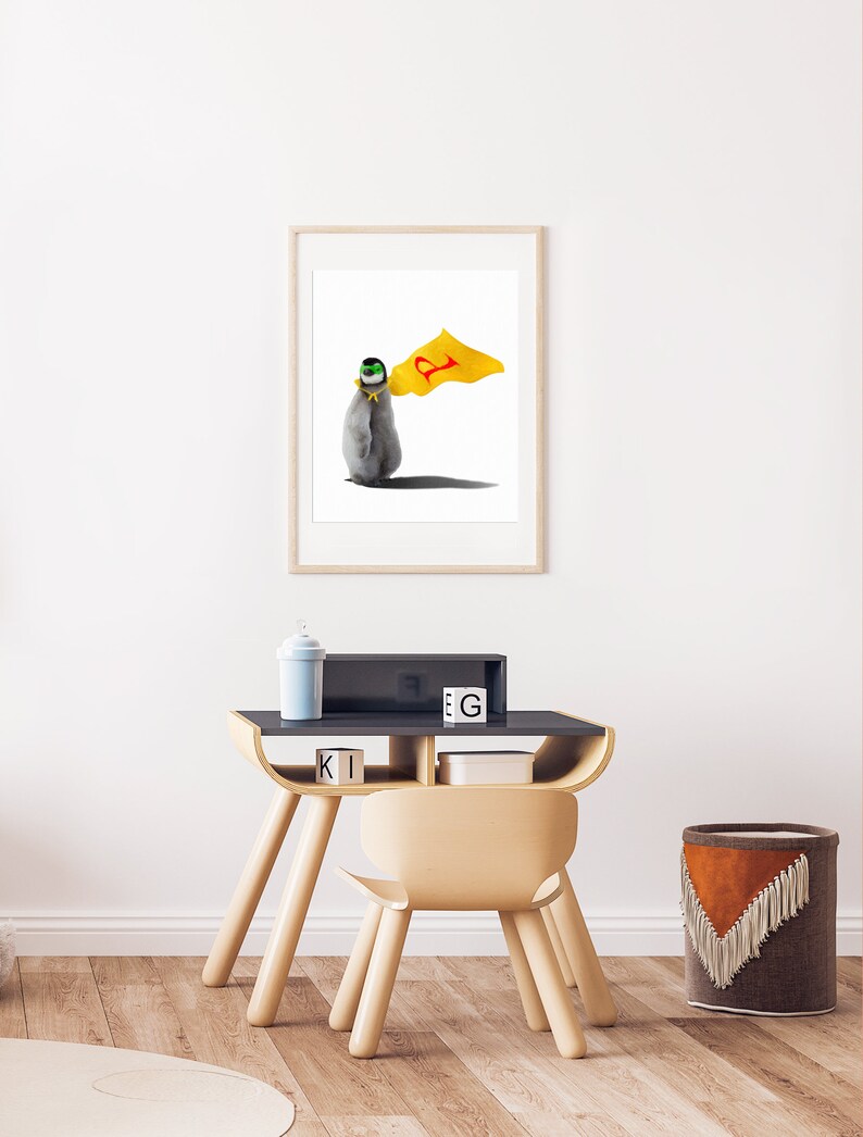 May include: A framed illustration of a penguin wearing a yellow cape with a red letter 'P' on it. The penguin is wearing a green and black mask. The illustration is on a white background.