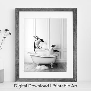May include: Black and white photograph of two penguins in a white bathtub with bubbles. The penguins are jumping out of the water. The bathtub is on a white tiled floor.
