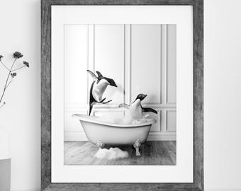 May include: A black and white framed wall art print featuring two penguins in a clawfoot bathtub filled with bubbles. One penguin is leaping into the air while the other sits inside the tub. The text Digital Download | Printable Art is below.