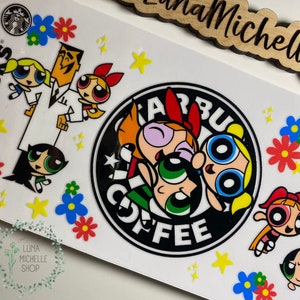 May include: White sticker featuring the Powerpuff Girls and Professor Utonium with a Starbucks logo. The design includes colorful flowers and stars. The words "Starbucks Coffee" are visible.