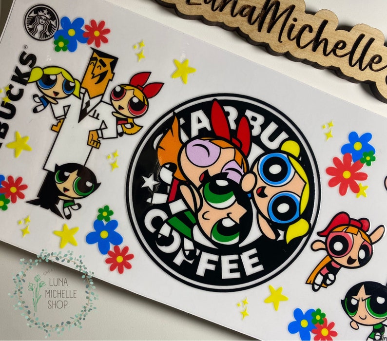 May include: White sticker featuring the Powerpuff Girls and Professor Utonium with a Starbucks logo. The design includes colorful flowers and stars. The words "Starbucks Coffee" are visible.