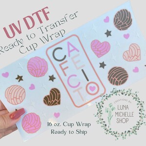 May include: A 16 ounce cup wrap with a design featuring the word "CAFE CITO" in pink and brown letters, surrounded by pink and brown hearts and stars. The design is ready to transfer using UV DTF.