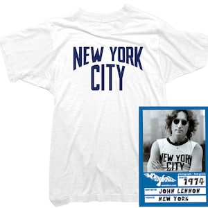 May include: White t-shirt with "NEW YORK CITY" printed in blue on the front. A blue and white photo of John Lennon wearing a white t-shirt with "NEW YORK CITY" printed in black on the front. The photo is from a concert in New York City in 1974.