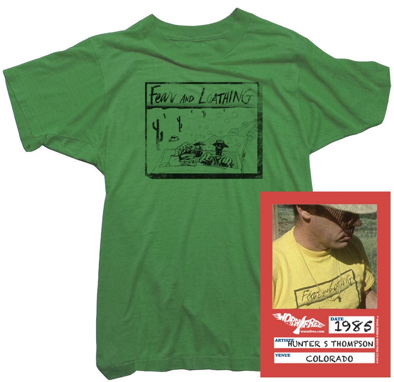 Puede incluir: Camiseta verde con una ilustraci&oacute;n en blanco y negro de una portada de libro que dice "Fear and Loathing". La camiseta tiene una peque&ntilde;a etiqueta con el texto "Fear and Loathing" y la fecha "1985". La etiqueta tambi&eacute;n dice "Hunter S. Thompson" y "Colorado".