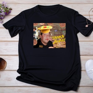 May include: Black t-shirt with a graphic of a person wearing a pizza on their head. The graphic includes the text "Tanka Jahari" and "Pizza Daddy".