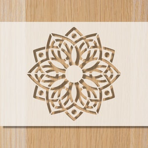 May include: A white wooden panel with a brown, intricate, laser-cut mandala design.