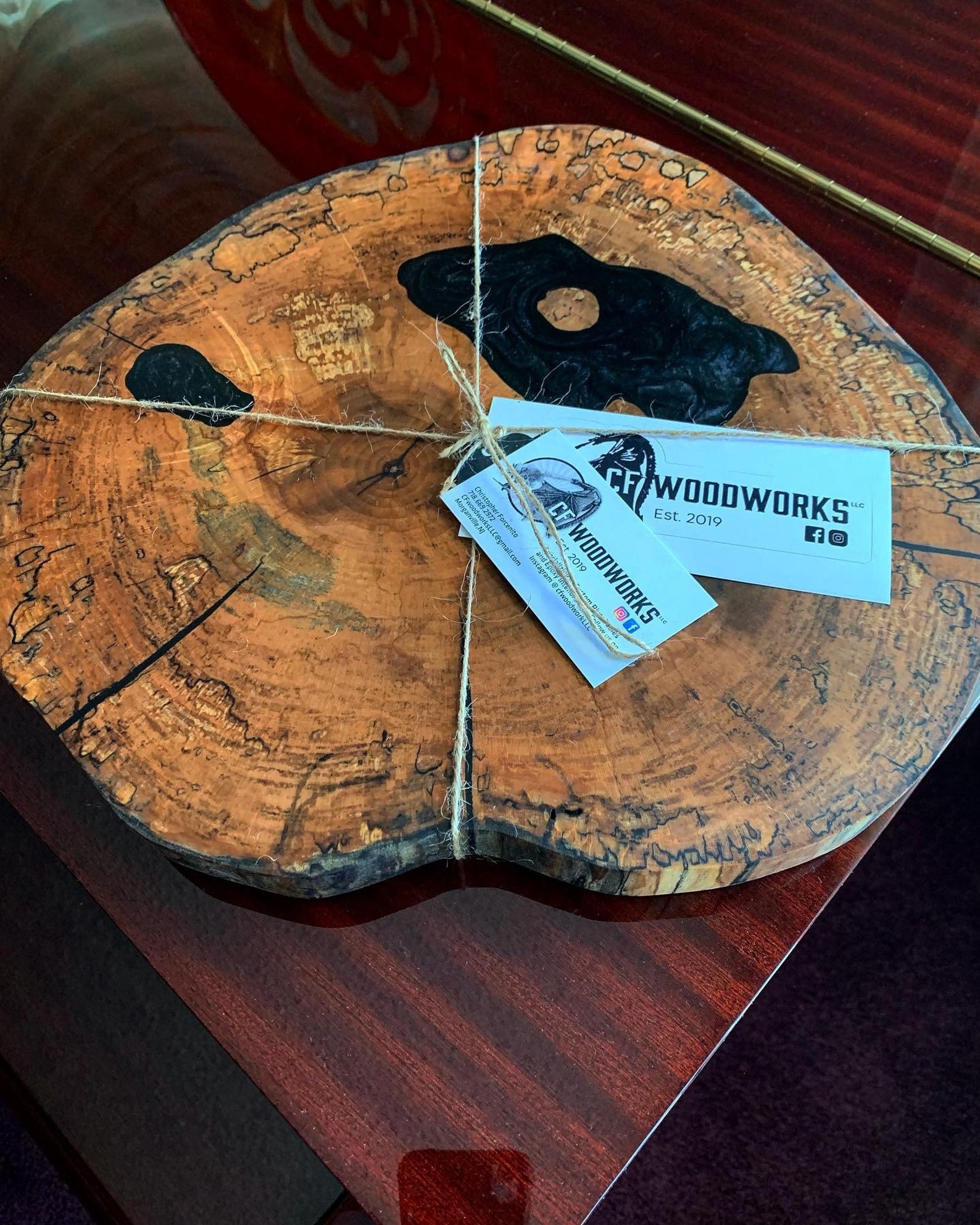 Live edge epoxy resin serving board displayed on a wooden table