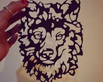 Hand drawn and hand cut paper wolf