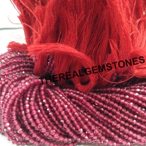 May include: A strand of faceted red gemstone beads, approximately 4mm in size, with a red tassel. The beads are strung on a clear thread and are ready to be used for jewellery making.