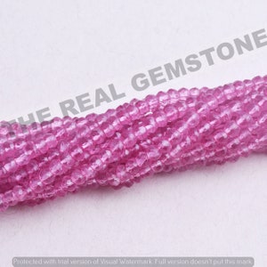 May include: A strand of pink gemstone beads. The beads are faceted and have a translucent appearance.