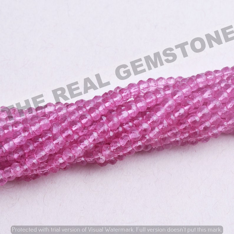 May include: A strand of pink gemstone beads. The beads are faceted and have a translucent appearance.