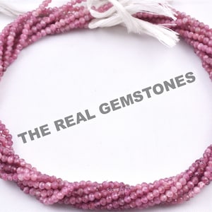 May include: A strand of pink tourmaline beads, approximately 2mm in size, with a faceted finish. The beads are strung on a white thread and are ready to be used for jewelry making.