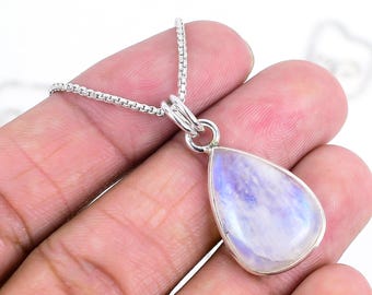 May include: A teardrop-shaped pendant necklace featuring a polished, iridescent moonstone. The stone is set in a silver bezel and hangs from a delicate silver chain. The moonstone displays a soft, ethereal glow with shades of blue and white.