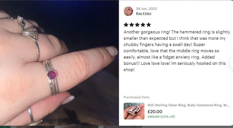 May include: A set of three silver rings, one with a red gemstone. The rings are stacked on a finger. The caption reads "Another gorgeous ring! The hammered ring is slightly smaller than expected but I think that was more my chubby fingers having a swell day! Super comfortable, love that the middle ring moves so easily, almost like a fidget anxiety ring. Added bonus!!! Love love love! Im seriously hooked on this shop!"  The text "925 Sterling Silver Ring, Ruby Gemstone Ring, W... &pound;20.00 &pound;40.00 (50% off)" is also visible.