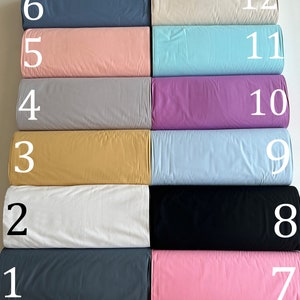 May include: Twelve fabric swatches in different colors and textures, numbered 1 through 12. The swatches are arranged in two rows of six, with the numbers on the right side of each swatch.