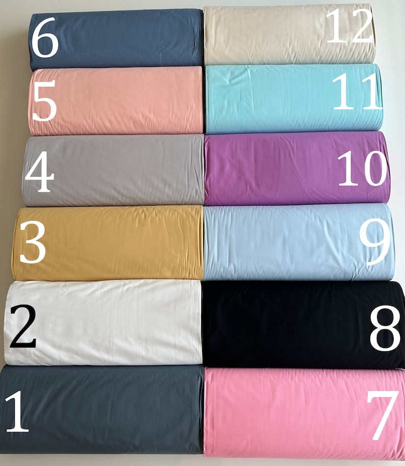 May include: Twelve fabric swatches in different colors and textures, numbered 1 through 12. The swatches are arranged in two rows of six, with the numbers on the right side of each swatch.
