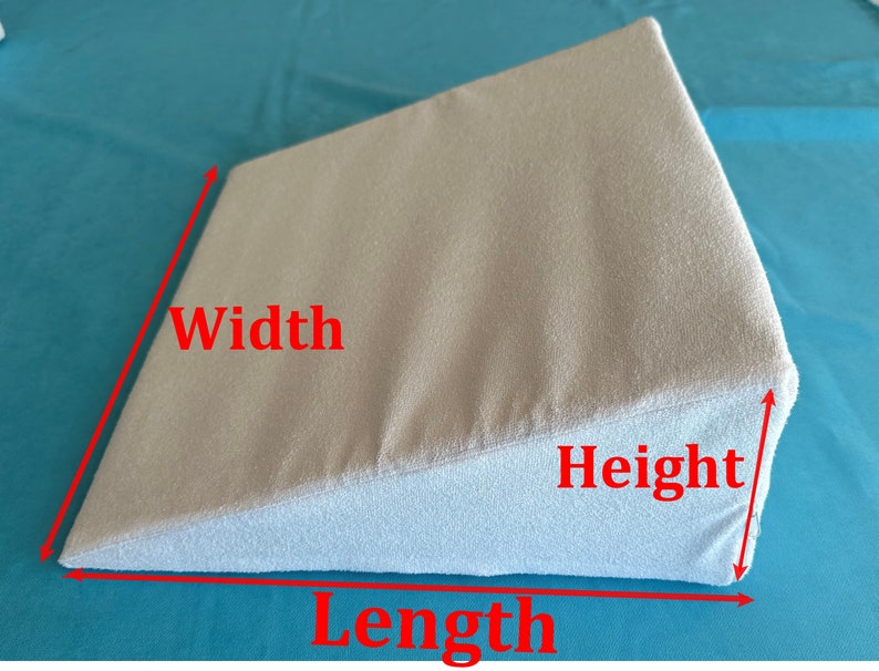May include: A light gray wedge pillow with measurements labeled "Width", "Length", and "Height".