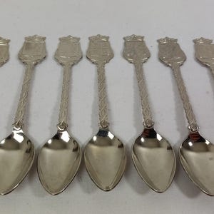 set of 7 vintage collectable silver plated metal spoons