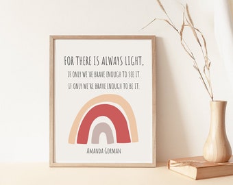 May include: A framed print with a quote by Amanda Gorman: "For there is always light, if only we're brave enough to see it. If only we're brave enough to be it." The quote is accompanied by a rainbow illustration in shades of red, orange, and gray.