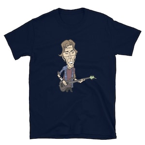 May include: A navy blue t-shirt with a cartoon illustration of a man playing a bass guitar. The man has brown hair, glasses, and is wearing a plaid shirt.