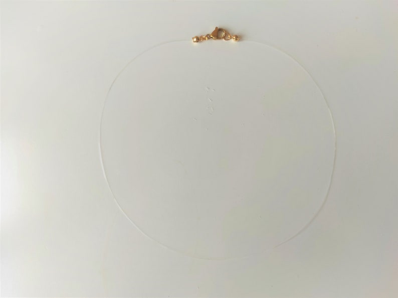 collier ras du cou femme fil nylon transparent pour pendentif avec fermoir acier inoxydable couleur acier ou doré longueur au choix doré (fermé)