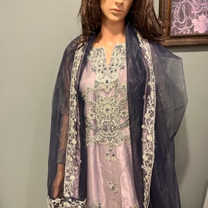 Lilac full embroidered silk gharara with net dupatta.
