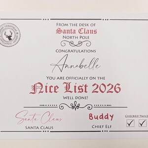 May include: A white certificate titled From the Desk of Santa Claus North Pole, featuring the text Congratulations Annabelle You Are Officially on the Nice List 2026. It includes a circular reindeer seal, signatures for Santa Claus and Buddy, and two checked boxes for Checked Twice.