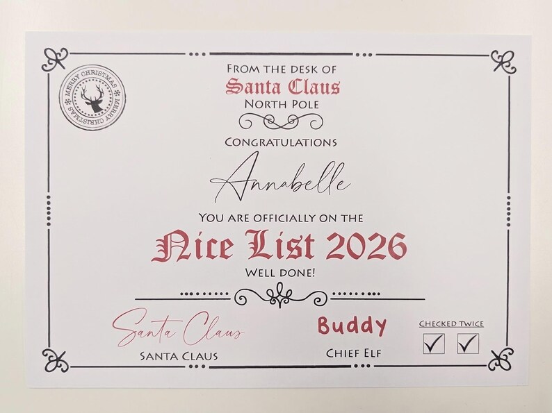 May include: A white certificate titled From the Desk of Santa Claus North Pole, featuring the text Congratulations Annabelle You Are Officially on the Nice List 2026. It includes a circular reindeer seal, signatures for Santa Claus and Buddy, and two checked boxes for Checked Twice.