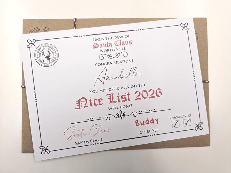 May include: A white certificate titled From the Desk of Santa Claus North Pole, featuring the text Congratulations Annabelle You Are Officially on the Nice List 2026. It includes a reindeer stamp, a signature, and a checked twice box.