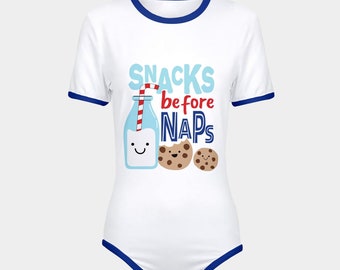 May include: White baby onesie with blue trim and the text "SNACKS before NAPS" in red, blue, and white. A cartoon milk bottle with a straw and a smiling face is next to two cartoon cookies.