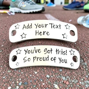 May include: Two silver shoe tags with black text and star designs. The top tag reads "Add Your Text Here." The bottom tag says "You've got this! So proud of You."