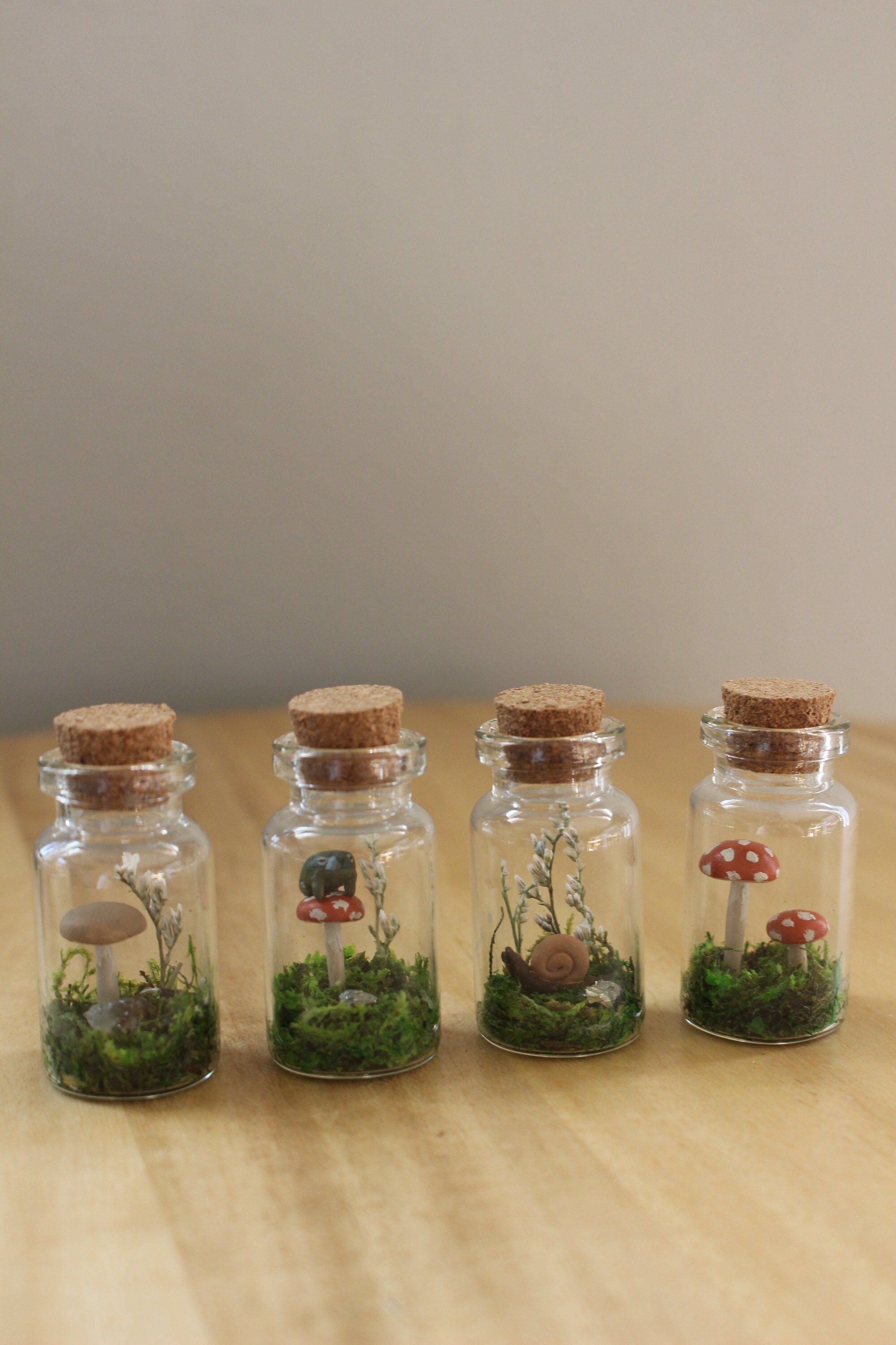 Tiny Jar Terrariums With Dried Moss and Clay Figures for Nature Lovers