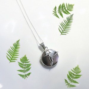 Sterling silver locket. Small round silver locket with silver Hummingbird charm.