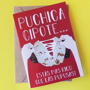 May include: Red card with white text that reads "Puchica Cipote... Estas mas rico que las pupusas!"  A hand is tearing the card to reveal a brown and red food item.