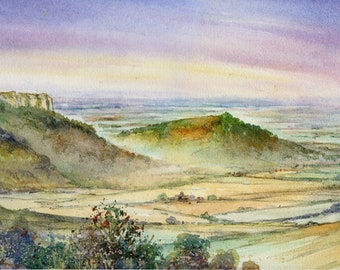 May include: A watercolor painting depicting a scenic landscape with rolling hills, a distant cliff, and a valley with fields and trees. The sky is a soft purple and pink, with a hint of blue in the distance.