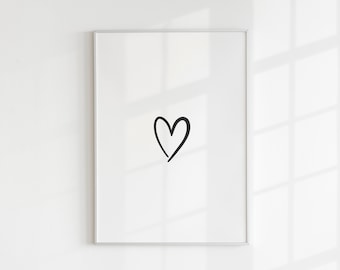 Può includere: Una stampa incorniciata con un semplice cuore nero disegnato a mano su uno sfondo bianco.