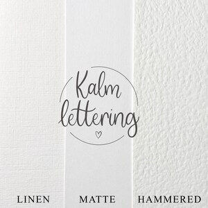May include: Three white paper samples with different textures: linen, matte, and hammered. The word "Kalm lettering" is written in a circle on the matte sample.