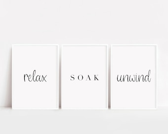 May include: Three white framed prints with black text. The prints read "relax", "SOAK", and "unwind".