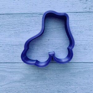 May include: Purple plastic roller skate cookie cutter.