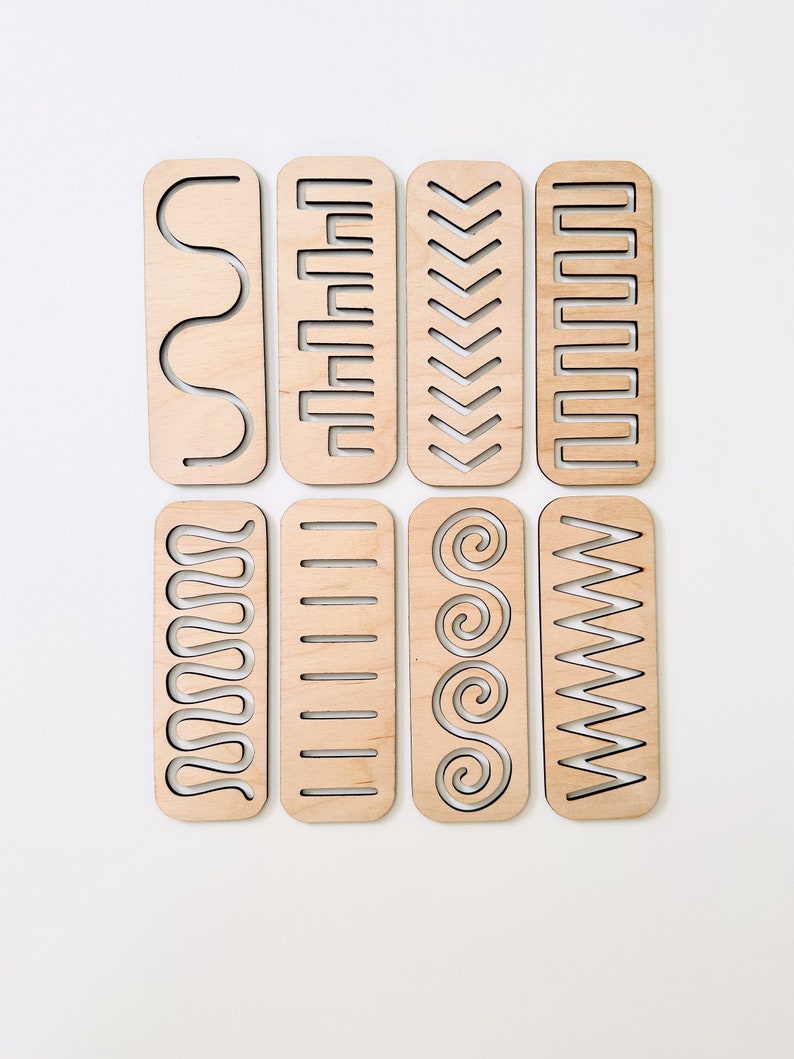 May include: Eight wooden bookmarks with different geometric patterns cut out. The patterns include waves, zigzags, squares, and spirals.