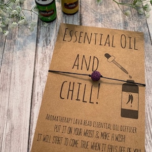 May include: A brown card with the text "Essential Oil and Chill!" and a purple lava bead bracelet. The card also includes the text "Aromatherapy Lava Bead Essential Oil Diffuser Put it on your wrist & make a wish! It will start to come true when it falls off of you! Alyssa Ashley Designs."
