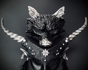May include: Two masquerade masks, one black wolf mask and one black and silver horned mask with rhinestones and feathers.