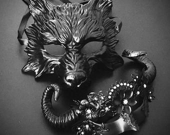 May include: A black wolf mask with intricate details and a black headband. The mask is paired with a black headband adorned with rhinestones and floral accents.