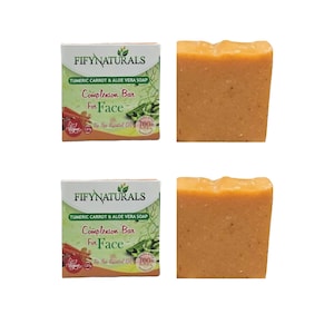 May include: Two bars of orange soap and two boxes of Fifynaturals Tumeric Carrot & Aloe Vera Soap. The boxes have green and white text that reads "Complexion Bar For Face". The soap is vegan and contains tea tree essential oil.