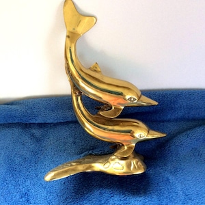 Brass dolphins statue